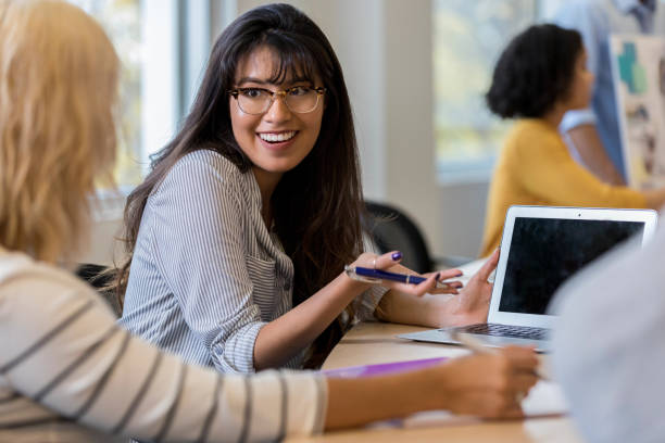 istock Smiling young businesswoman talks withe unrecognizable colleague 1135118252