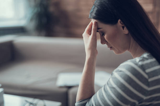 istock Side view depressed lady situating in apartment indoors 1135118391