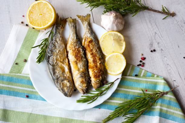 istock Fried fish with lemon rosemary and pepper. 1135121213