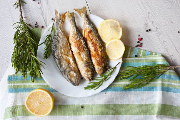 istock Fried fish with lemon rosemary and pepper. 1135121230