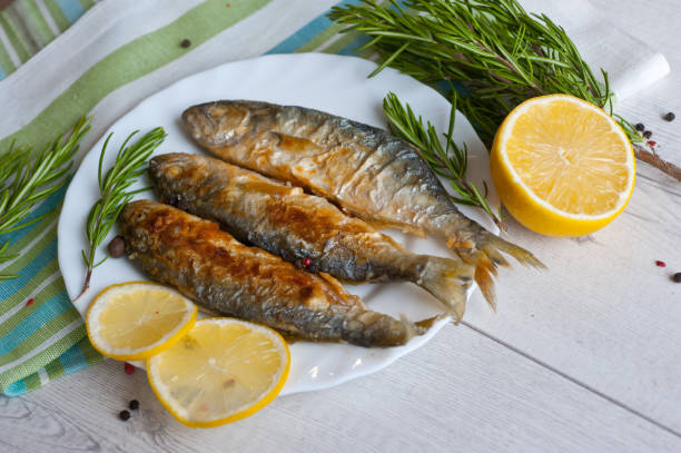 istock Fried fish with lemon rosemary and pepper. 1135121252