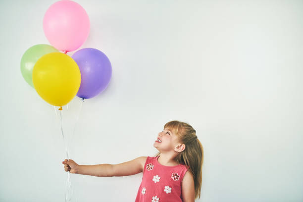 happy little girl  outdoors with balloons