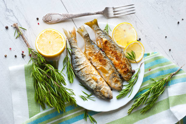 istock Fried fish with lemon rosemary and pepper. 1135121288