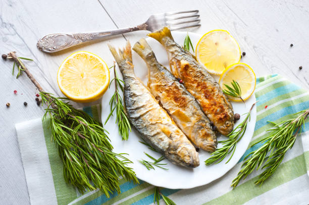 istock Fried fish with lemon rosemary and pepper. 1135121413