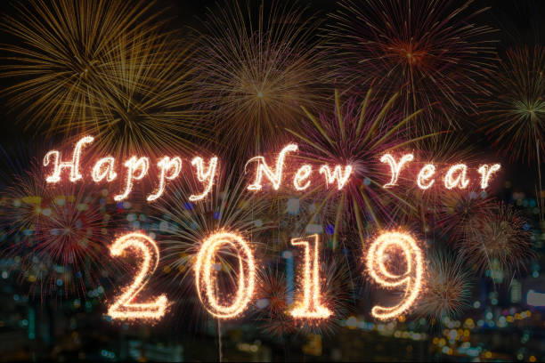 istock Happy new year 2019 written with Sparkle firework on fireworks with photo blurred of cityscape dark background, celebration and greeting cards concept 1135121488