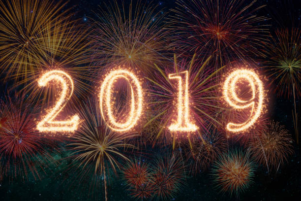 istock 2019 written with Sparkle firework on fireworks with dark background, Happy new year celebration and greeting cards concept 1135121493