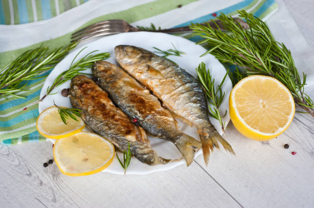 istock Fried fish with lemon rosemary and pepper. 1135121519
