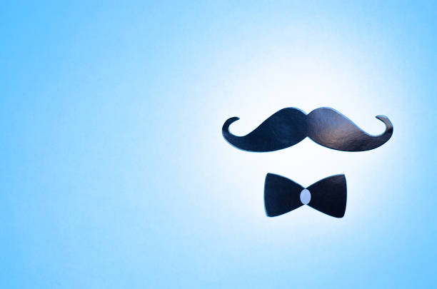 Postcard with a blue mustache and bow tie to the father's day. Imitation of the head of a man.