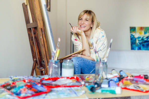 istock Young, blond and beautiful woman painting 1135123018