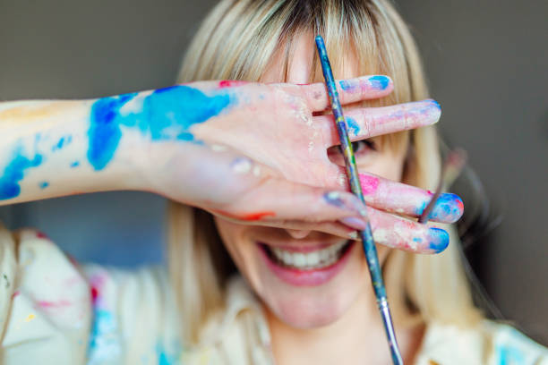 istock Beautiful blonde woman playing with colors 1135123096