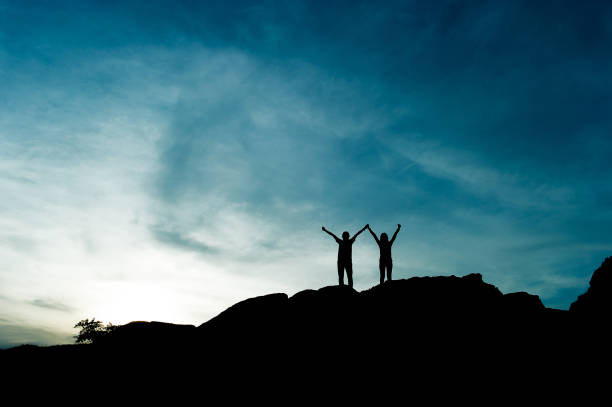 Silhouettes of travelers on the hill with blue sky, Doi Mongjong, Thailand