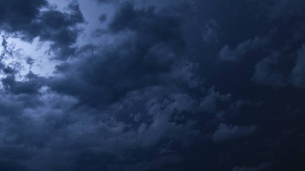 istock A flash of lightning behind the clouds in the night sky. 1135124708