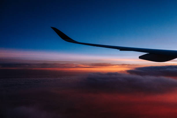 istock Airplane Wing in Flight from Window Sunrise Sky 1135125120