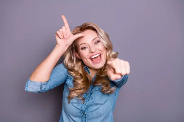Close-up portrait of her she nice cute lovely charming attractive wavy-haired cheerful lady showing mocking sign gesture opened mouth isolated over gray violet purple pastel background.
