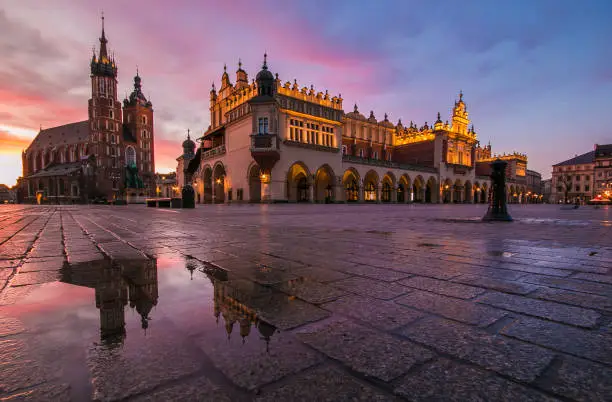 Photo of View of Rynek Główny medieval square at sunrise with puddle in Krakow at sunrise, Poland