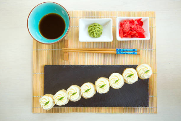 istock fresh crunchy fried shrimp sushi roll isolated on black background 1135128260