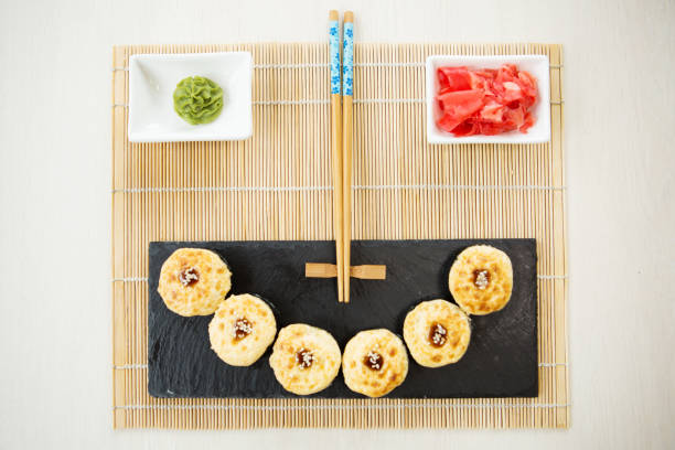 istock Sushi rolls, maki, nigiri Set served for two on black stone slate on dark background copy space 1135130149