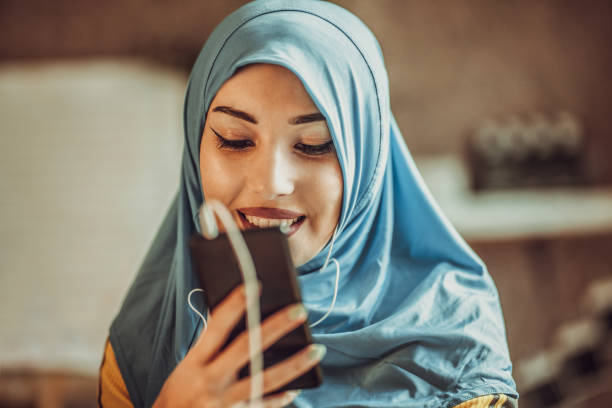 istock Young Muslim Women Playing Smartphone 1135130161
