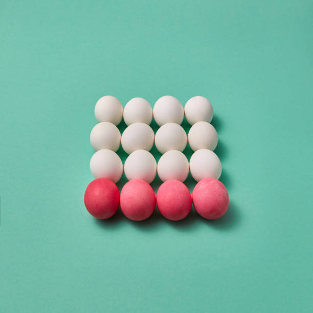 istock Beautiful Easter composition made of painted pink and white eggs on a green background with copy space. Billiard game concept. 1135130551