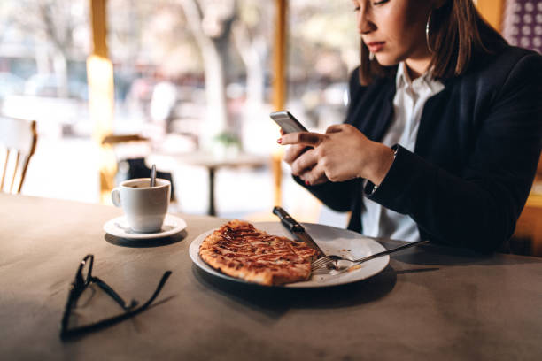istock Young woman enjoying pizza and coffee 1135131499