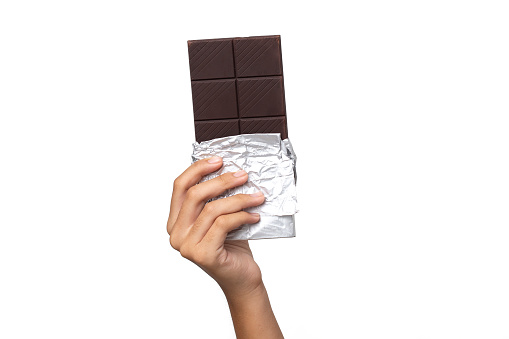 Close-up hand holding Chocolate isolated on a White Background