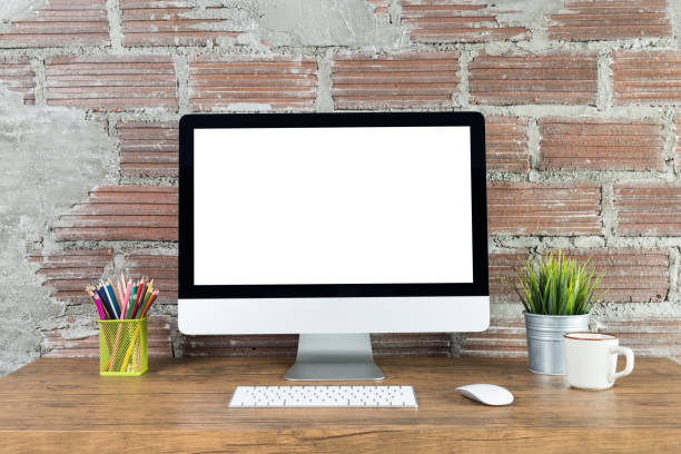 istock workspace with computer with blank black screen, and office supplies on a wooden desk 1135132955