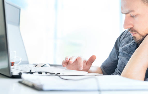 istock Man using mobile phone and laptop, working at home 1135132960