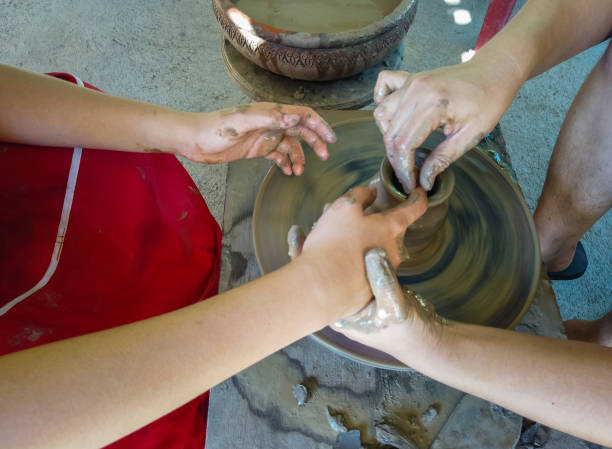 Hands molding machine to mold clay. The work done by hand