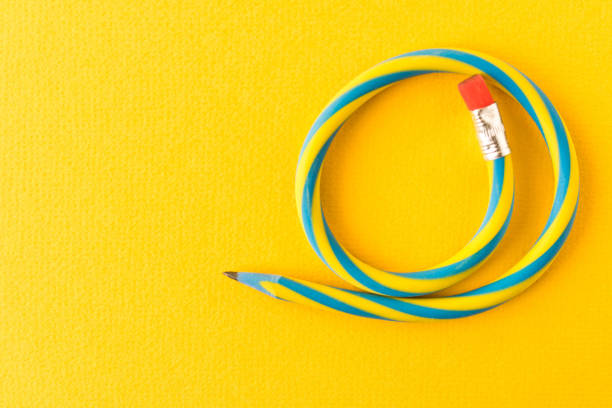 istock Flexible pencil . Isolated on yellow background. Bending pencil. 1135133993