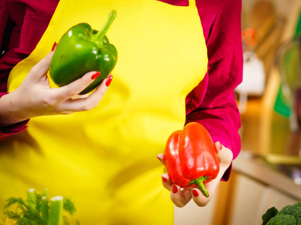 istock Woman holding bell peppers paprika 1135135336