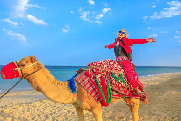 Photo of Woman riding camel