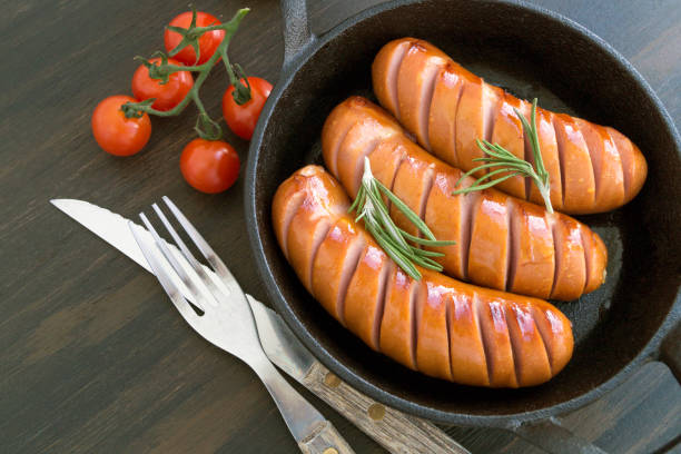 istock Fried sausages on a cast iron pan. 1135137683