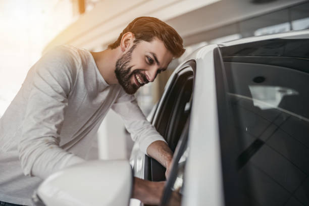 istock Man in car dealership 1135138360