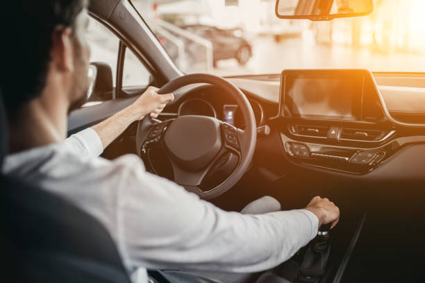 istock Man in car dealership 1135138560