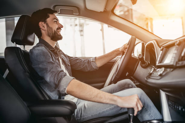 istock Man at car dealership 1135139386