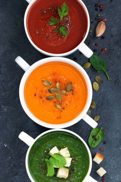 istock assortment of vegetable cream soup on a dark background, vertical top view 1135139562