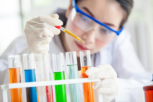 Closeup of a female scientist filling test tubes with pipette in laboratory  science laboratory research and development concept