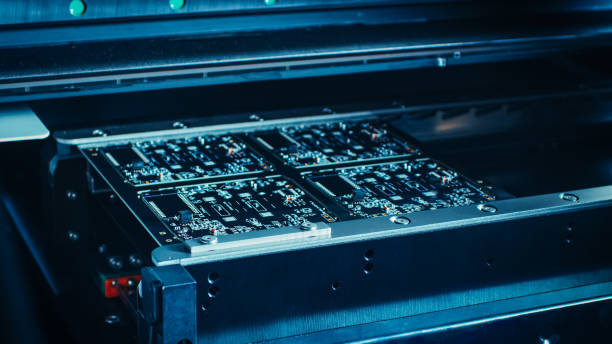 istock Factory Machine at Work: Printed Circuit Board Being Assembled with Automated Robotic Arm, Surface Mounted Technology Connecting Microchips to the Motherboard. Macro Close-up. 1135140269