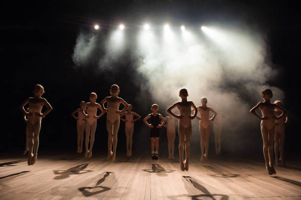 happy children doing ballet jump - round bale imagens e fotografias de stock