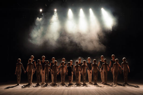 a large group of children have a reverence at the end of the performance. - round bale imagens e fotografias de stock