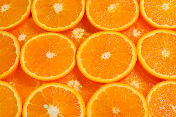 istock Slices of oranges as a background, top view. 1135142756