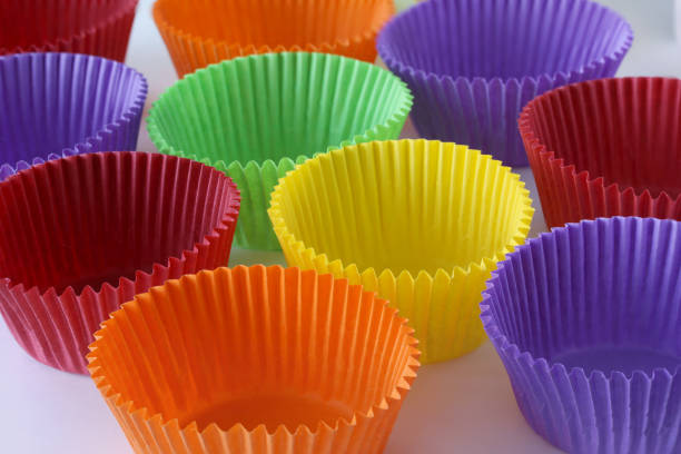 istock Many colorful empty paper forms capsules for muffins and cupcakes on white background - baking dessert - close up on white background 1135143693