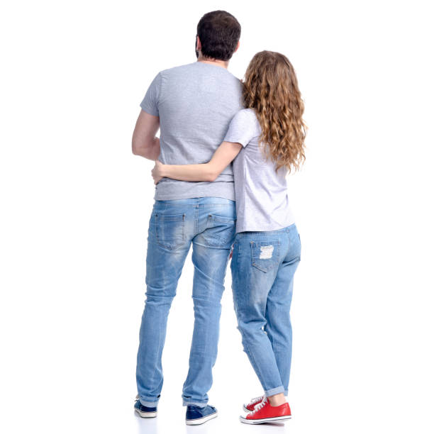 istock Woman and man in jeans standing looking hugging 1135144609