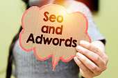 closeup  woman holding seo and adwords