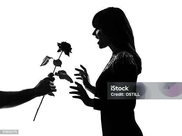 Silueta Hombre Mano Con Una Flor Rosa Foto de stock y más banco de imágenes de Hombres jóvenes - Hombres jóvenes, Silueta, Adulto