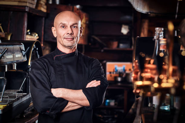 istock Confident chef posing with his arms crossed and looking at a camera in restaurant kitchen. 1135149080