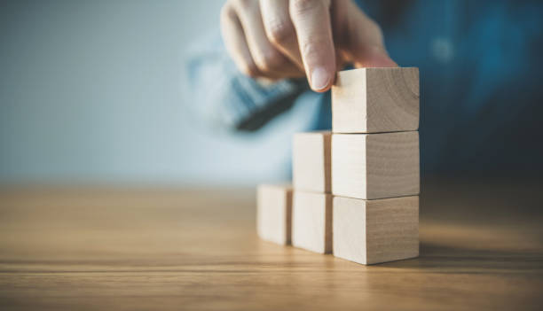istock Hand arranging wood cube stacking as step stair. Business concept growth success process. 1135149192
