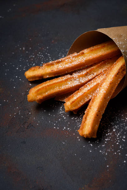 istock Churro fried sticks in paper bag 1135149366