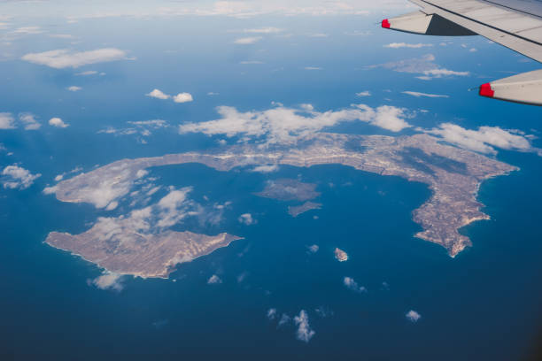 Thirasia and Santorini island with Oia town in Greece, view from above, airplane window view