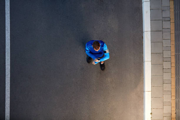 istock Top view of runner standing and watching at wristwatch. 1135152371